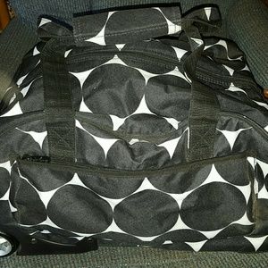 Thirty One carry on, with wheels. Lots of room.